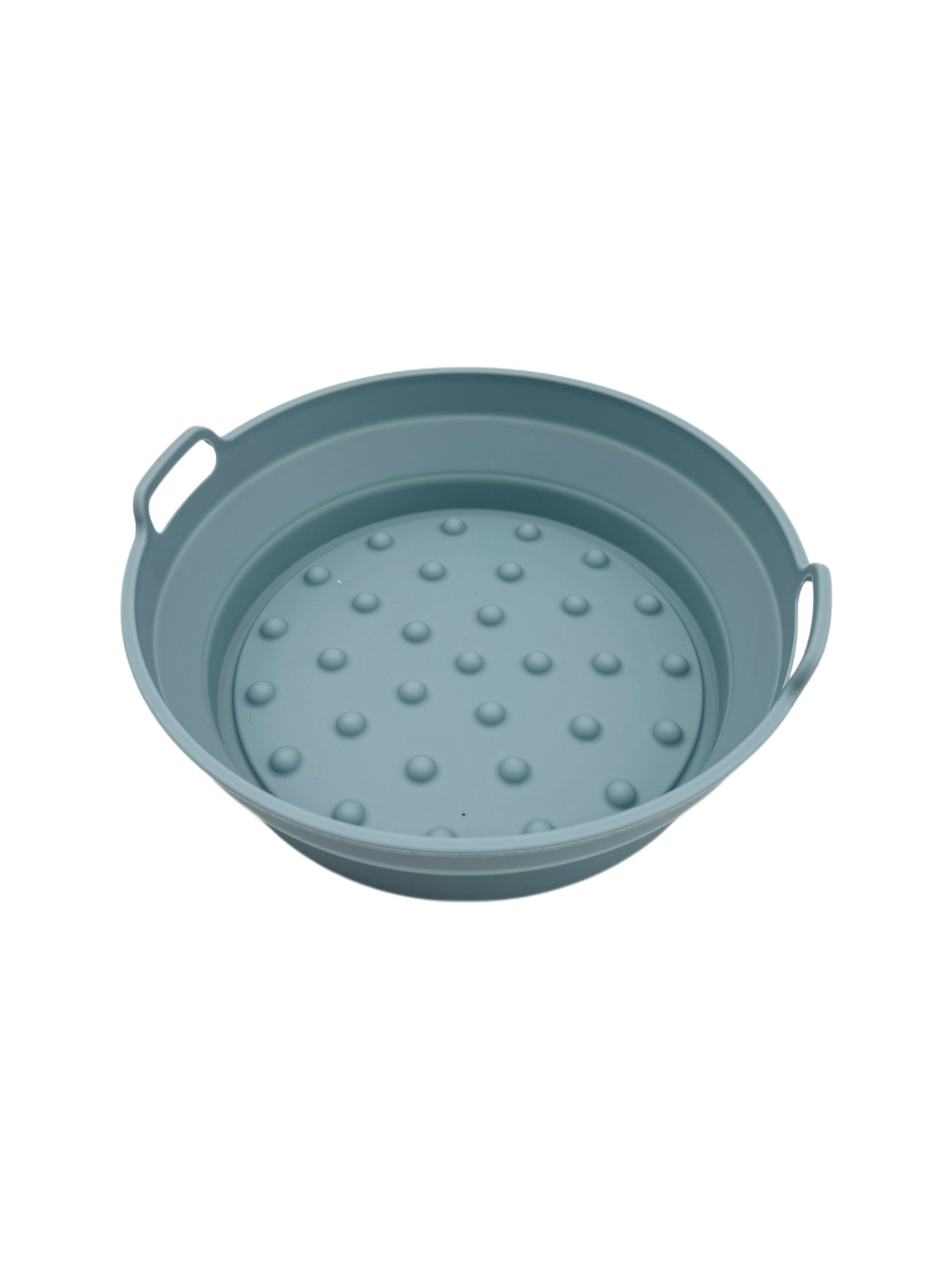 Round silicone air fryer pan in a neutral kitchen setting